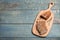 Cut buckwheat baguette with thyme on light blue wooden table, top view. Space for text