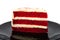 Cut cake Red velvet chocolate on black plate isolated