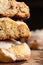 Cut of a cinnamon roll with cream cheese on a stone background close up. Front view stack of baked yeast buns