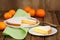 Cut clementine pie with clementines and knife on wooden background