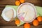 Cut clementine pie with clementines and knife on wooden background top view