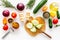 Cut different fresh vegetables on cutting board for cooking vegetable stew. White background top view