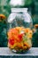 Cut edible multicolored nasturtium flowers in a glass jar