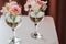 Cut flowers in glasses of water. Mini composition for table decoration