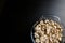 Cut forest champignon mushrooms in glass bowl on dark background or black wooden table.