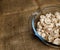 Cut forest champignon mushrooms in glass bowl standing on table covered with sackcloth.