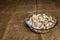 Cut forest champignon mushrooms in glass bowl standing on table covered with sackcloth.