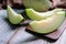 Cut of fresh sweet green melon on the wooden table. Fruits or healthcare concept. Selective focus, close up