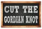 CUT THE GORDIAN KNOT words on black wooden frame school blackboard