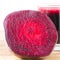 Cut half beetroot and fresh beet juice in glass on wooden table, white background.