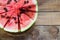 Cut in half watermelon on old wooden table. Red ripe fruit wood background top view image