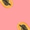 Cut in halved ripe juicy papayas on cherry pink background. Tropical fruits summer vacationc
