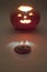 Cut off top of jack o lantern on blurred background. mysterious darkness lights. selective focus