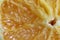 Cut of the orange close-up. Macro photo of eating orange fruit. Orange fruit background