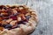 Cut out of a fresh plum cake on a rustic wooden table, summer