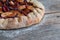 Cut out of a fresh plum cake on a rustic wooden table, summer