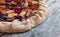 Cut out of a fresh plum cake on a rustic wooden table, summer