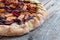 Cut out of a fresh plum cake on a rustic wooden table, summer