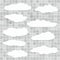 Cut out lined paper clouds are stuck on gray squared pattern or wall