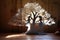 cut-out paper tree with dancing shadows on a wooden table