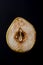 Cut out section of overripe pear on black background