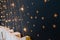 Cut and pasted gold stars on a dark wall of kids room with lights. Baby room interior concept. Handmade decoration with stickers o