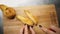 cut pear. cooking. close-up. female hands cut fresh, sweet pear into slices, with a knife, on a wooden plank.