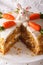 Cut a piece of carrot cake decorated with bunny close-up. Vertical