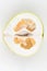 Cut pomelo on a white background. Unripe. Small inside. Place for an inscription. Easy cut. View from above. close-up