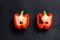 Cut red sweet pepper, two halves. Black background. Top view. Space for text