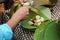 Cut or serve lontong or rice steam in wrapped banana hand seller with green banana leaf