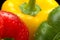 Cut shot green, red, yellow bell pepper background with water drop