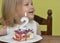 Cut slice of birthday cake 2 years for Small girl