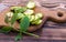 Cut into slices and lying on cutting wooden vintage board ingredients for tincture of green walnuts in a wooden ecological plate