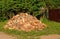 Cut and split firewood stacked in a pile near the house