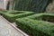 Cut squares of flowerbed edging in a historic garden made of boxwood hedges. courtyard of the castle along the cobblestone path ro