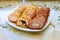 Cut stuffed meatloaf roll on white plate for party