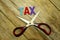Cut of tax Concept scissors and the colorful wooden alphabet on wooden background