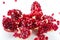 Cut-up dissected garnet fruit pomegranate seeds on whit