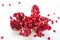 Cut-up dissected garnet fruit pomegranate with seeds on white ba