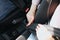 Cut view of young woman`s hands locking seat belt in car. Sitting alone. Close up.