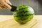 Cut a watermelon with a knife.
