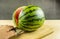 Cut the watermelon with a knife in half.