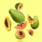 Cut and whole papaya fruits falling on light yellowish green background