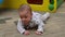 Cute 3 months old baby boy enjoying tummy time