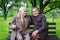 Cute 80 plus year old married couple posing for a portrait in their garden. Love forever concept