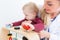 Cute active baby boy playing with toys during physical examination