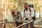 Cute active couple standing together on the wooden bridge