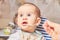 Cute adorable baby eating porridge with a spoonful of the concept of proper nutrition