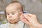 Cute adorable baby eating porridge with a spoonful of the concept of proper nutrition